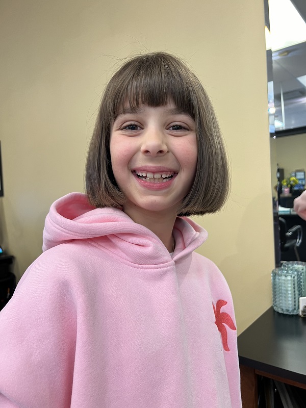 Sofia Balcells happy input image at 10 years old in pink sweatshirt and bangs